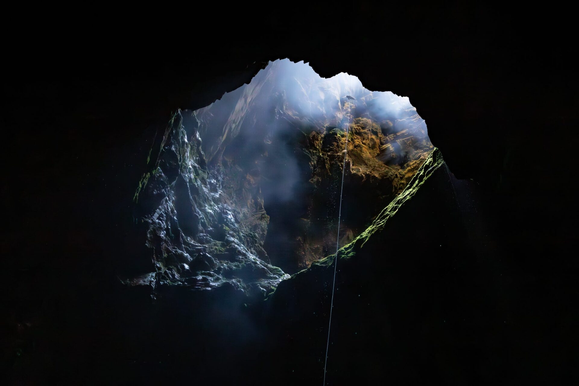 Filming person repelling during adventure race series in Harwoods Hole, New Zealand