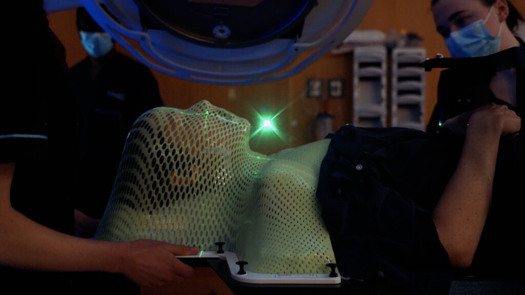 Helene Barron during radiation treatment, mesh mask fitted
